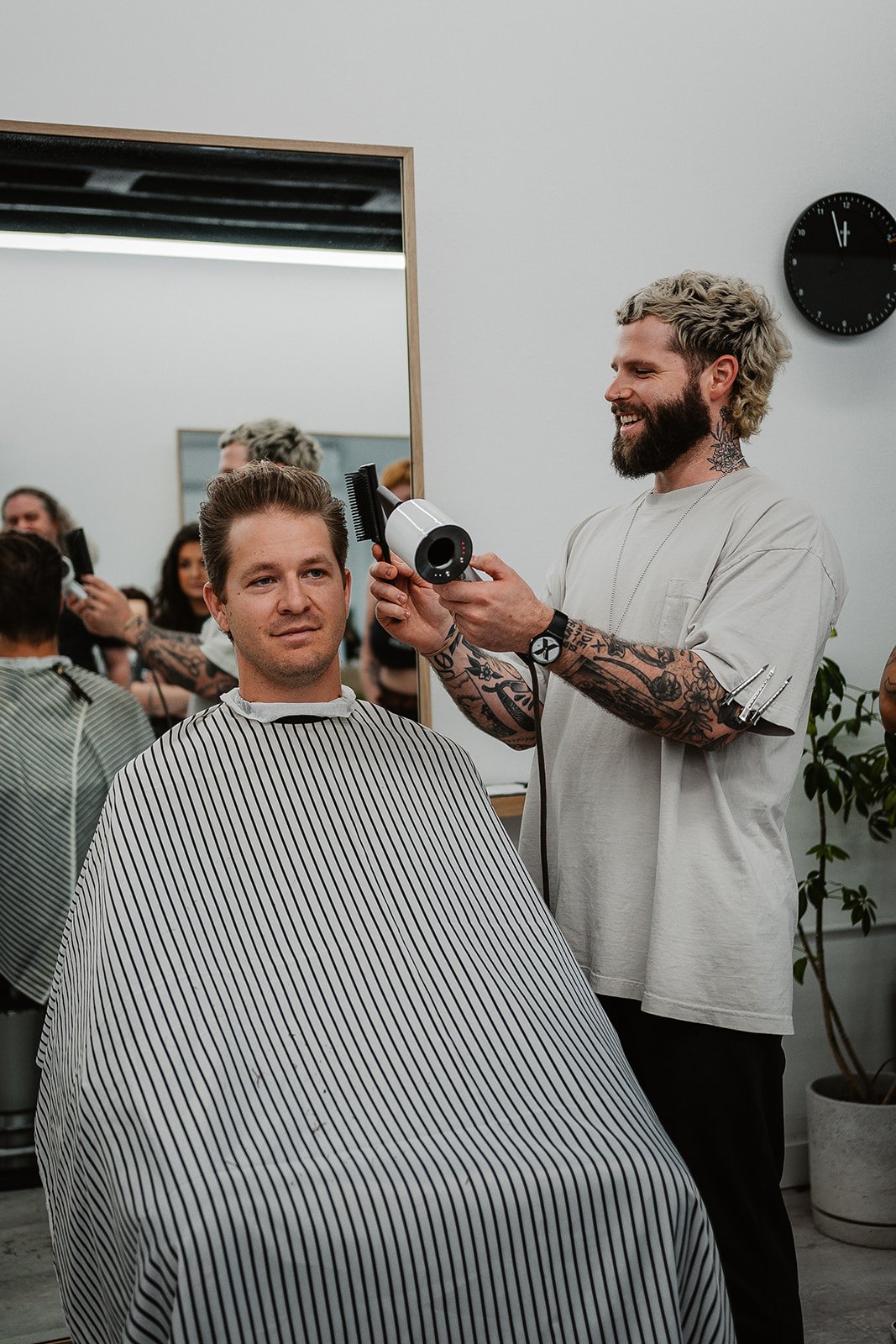 a mailroom barber styling a client behind the chair