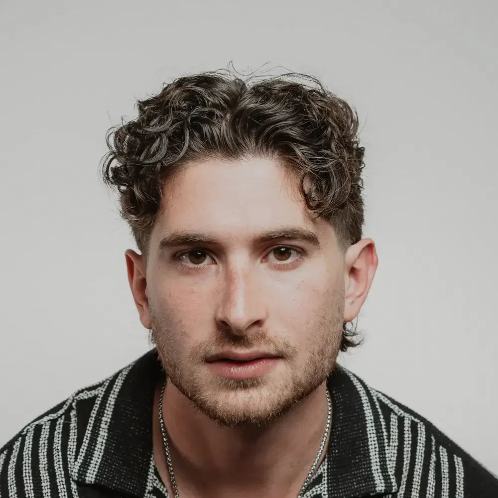 Men's mid length center part hair style